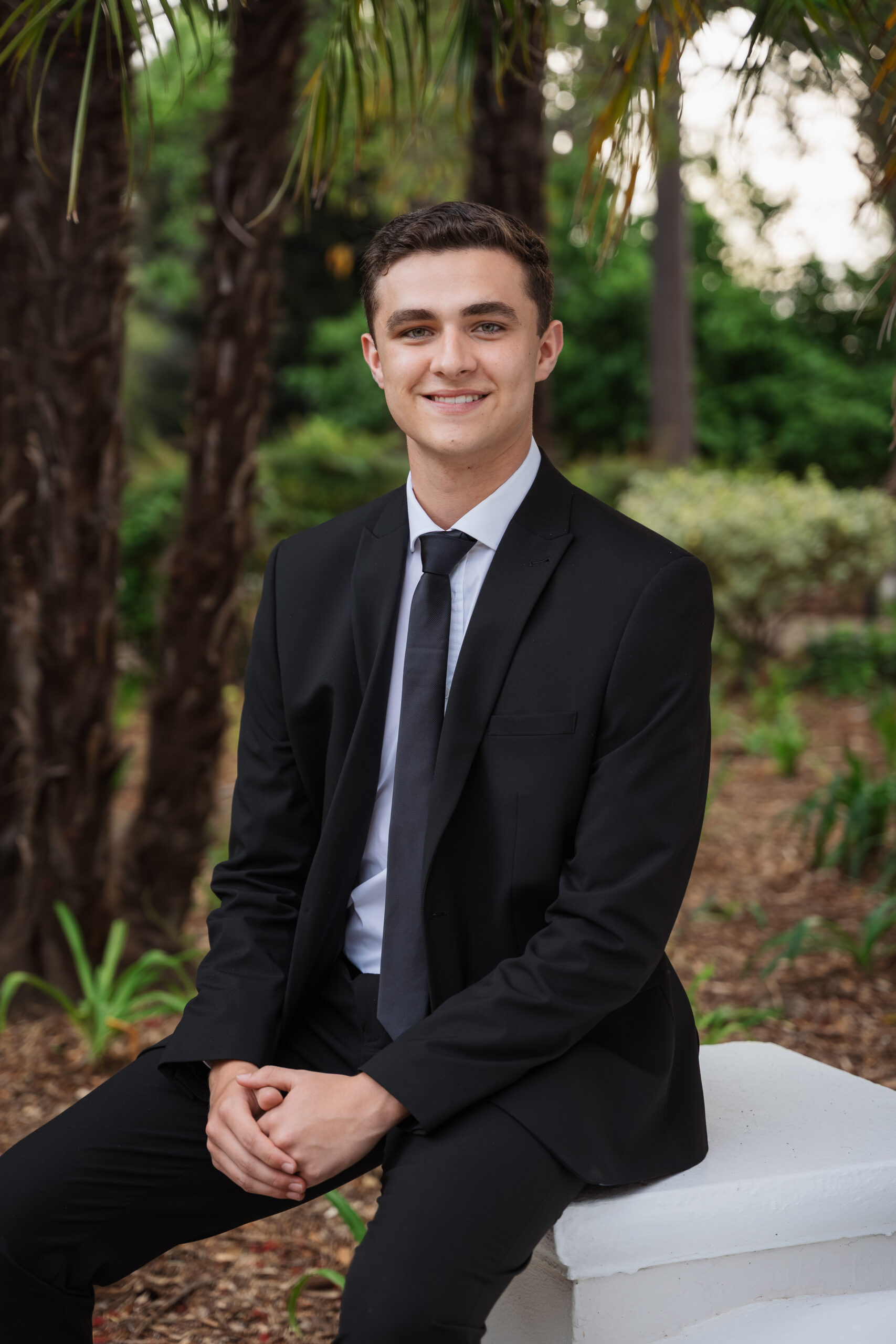 Person in a suit sitting outside